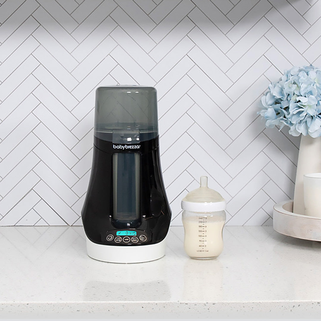 Mom using Baby Brezza Bottle Warmer