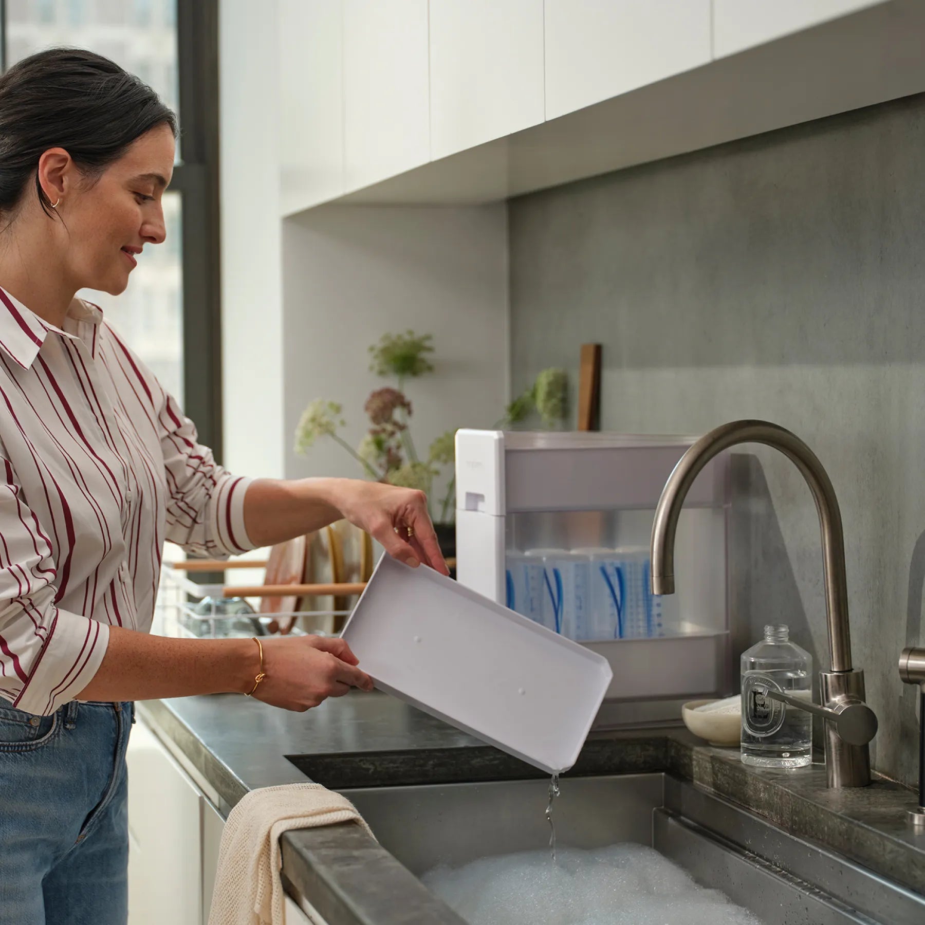 Woman washing drying rack in a modern kitchen