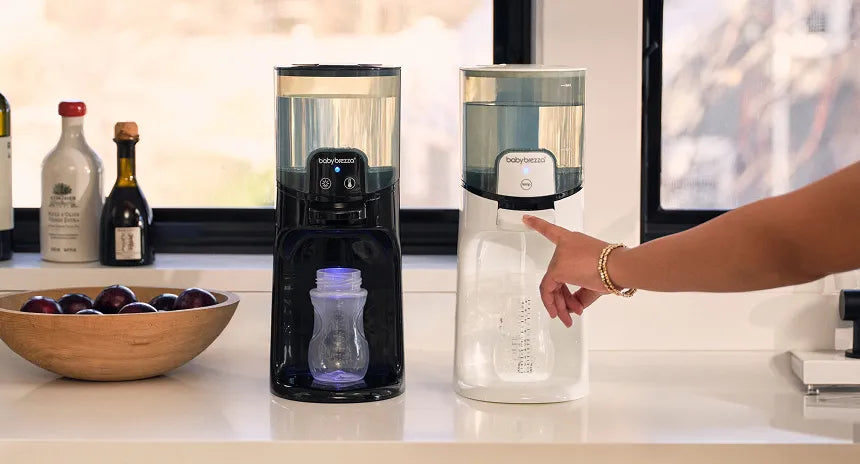 Two warm water dispensers on a kitchen counter with a hand reaching towards one of them.