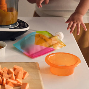 Person preparing sweet potatoes in the baby brezza one step food maker deluxe with puree in food pouch