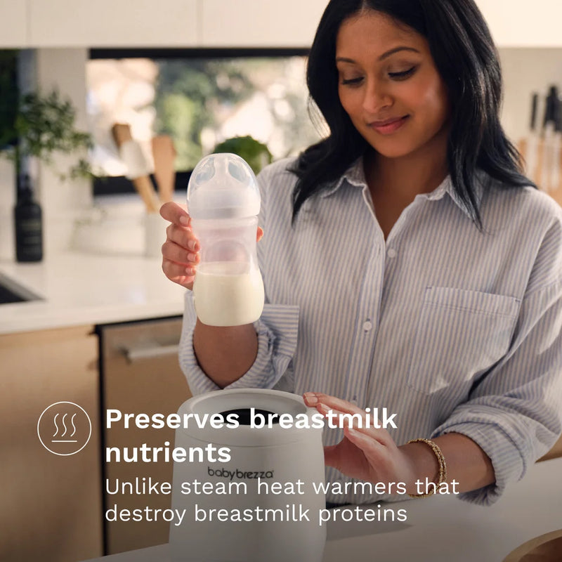 Woman holding a breastmilk storage bag and bottle in a kitchen setting for baby brezza storage bags