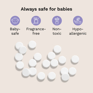 White round tablets scattered on a light beige background with text and icons stating 'Always safe for babies' and features like baby-safe, fragrance-free, non-toxic, and hypo-allergenic.