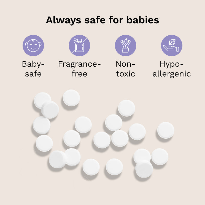 White round tablets scattered on a light beige background with text and icons stating 'Always safe for babies' and features like baby-safe, fragrance-free, non-toxic, and hypo-allergenic.