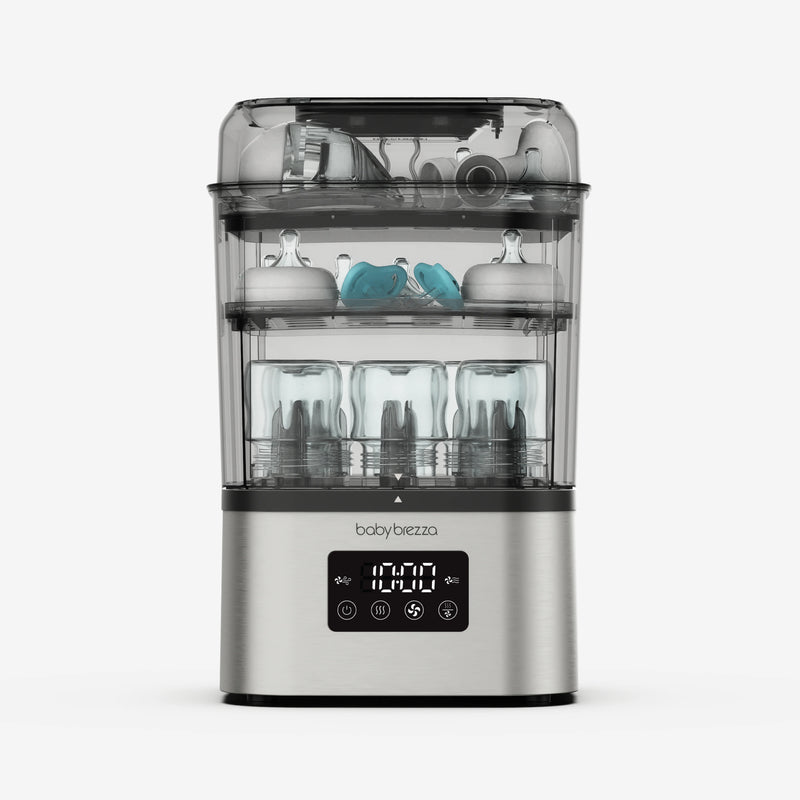 Baby Brezza SuperQuick baby bottle sterilizer and dryer in stainless steel with bottles and pump parts inside