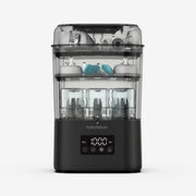 Baby Brezza SuperQuick baby bottle sterilizer and dryer in matte black with bottles and pump parts inside