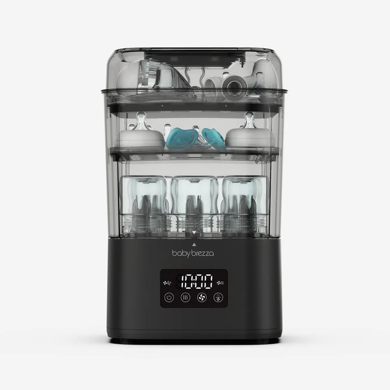 Baby Brezza SuperQuick baby bottle sterilizer and dryer in matte black with bottles and pump parts inside