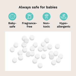 White baby tablets scattered on a white rectangular background, with the headline 'Always safe for babies' above four teal icons reading Baby-safe, Fragrance-free, Non-toxic, and Hypo-allergenic on a pale beige backdrop.