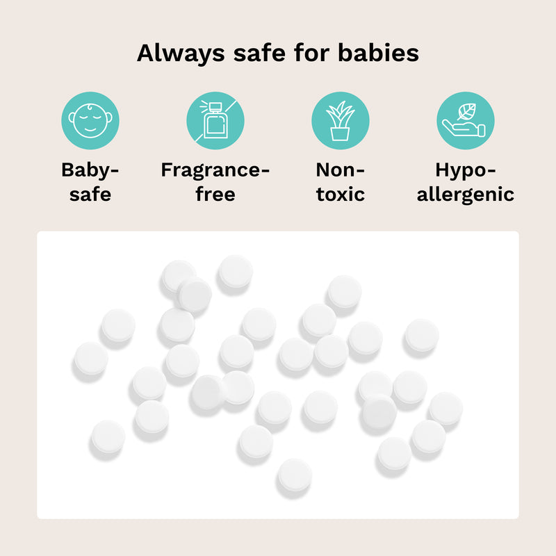 White baby tablets scattered on a white rectangular background, with the headline 'Always safe for babies' above four teal icons reading Baby-safe, Fragrance-free, Non-toxic, and Hypo-allergenic on a pale beige backdrop.