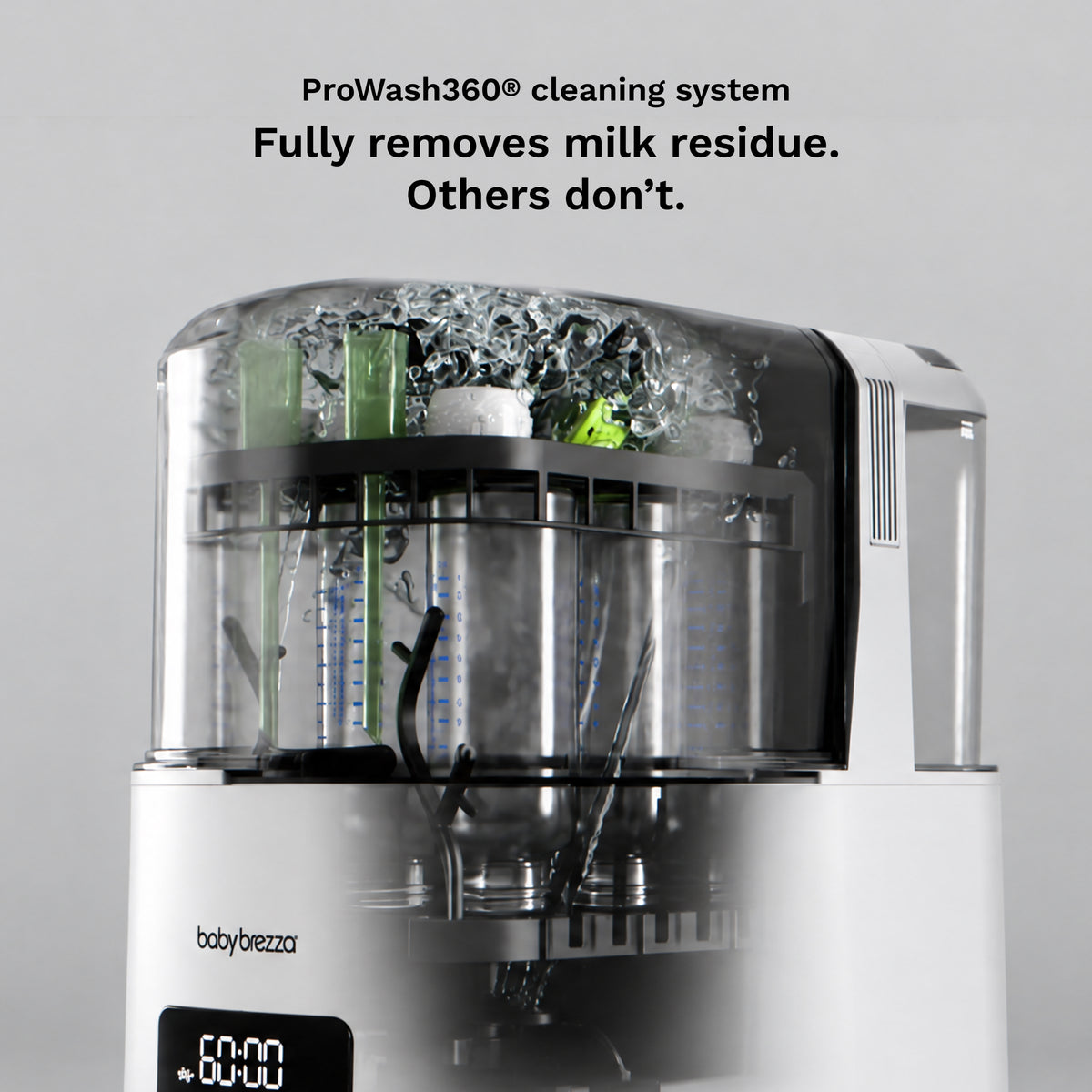 A baby bottle and breast pump cleaning system by baby brezza, shown with the lid open and internal spray and scrubber components visible. Black text at the top reads 'ProWash360® cleaning system Fully removes milk residue.