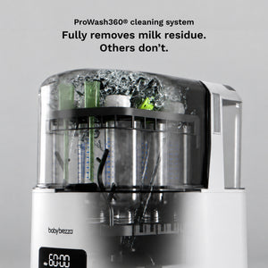 A baby bottle and breast pump cleaning system by baby brezza, shown with the lid open and internal spray and scrubber components visible. Black text at the top reads 'ProWash360® cleaning system Fully removes milk residue.