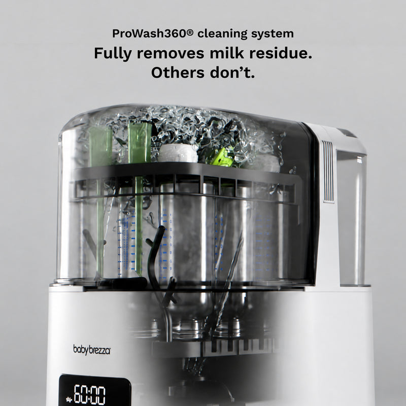 A baby bottle and breast pump cleaning system by baby brezza, shown with the lid open and internal spray and scrubber components visible. Black text at the top reads 'ProWash360® cleaning system Fully removes milk residue.