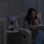 White Formula Pro Mini travel formula dispenser next to woman reading to her baby - product thumbnail