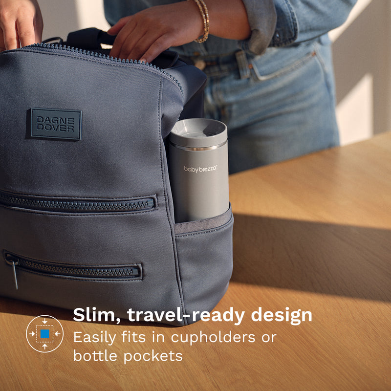 Person opening a gray bag with a Baby Brezza Portable Warmer