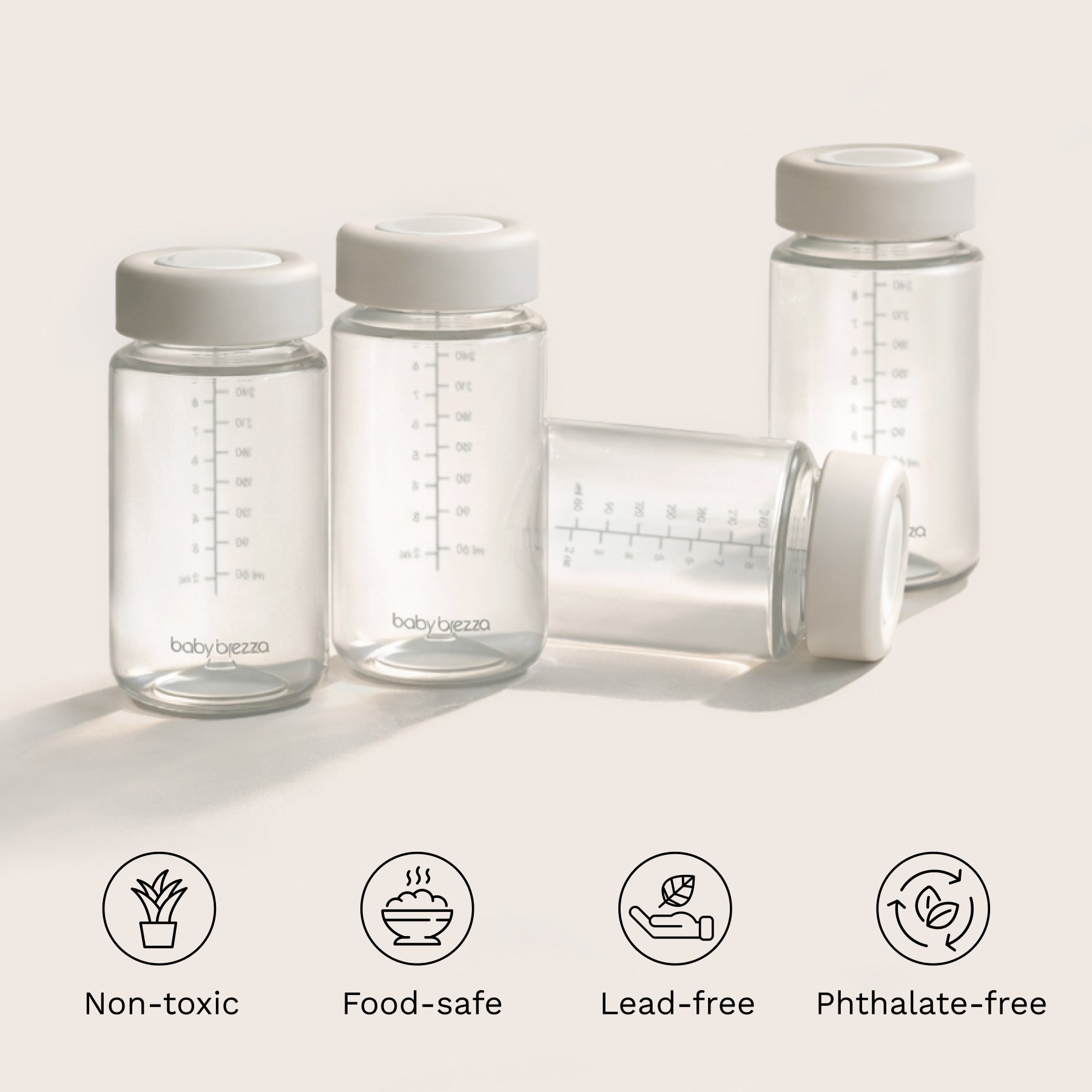 Clear baby bottles with white lids on a light background, featuring icons and text about safety features. Non-toxic, food-safe, lead-free, phthalate-free