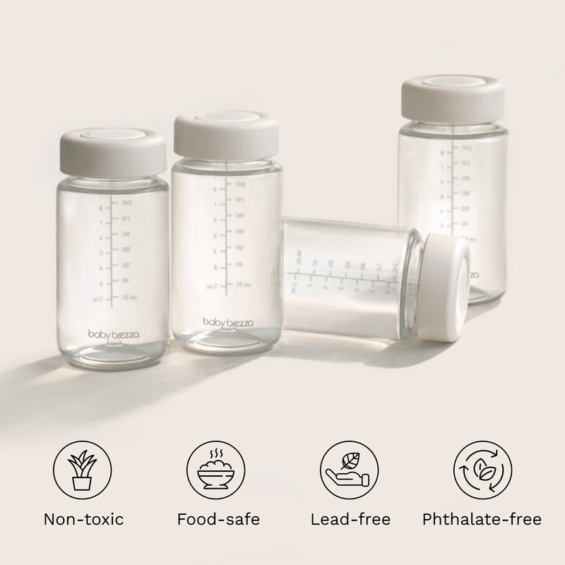 Clear baby bottles with white lids on a light background, featuring icons and text about safety features. Non-toxic, food-safe, lead-free, phthalate-free