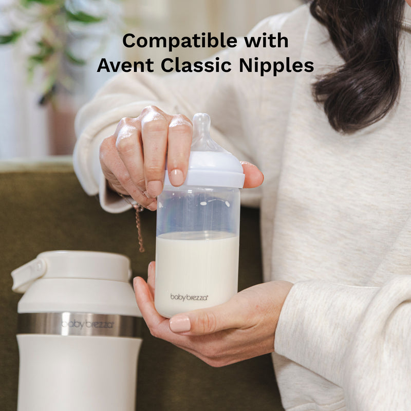 Person holding a baby bottle with milk, next to a thermos, with text 'Compatible with Avent Classic Nipples'.