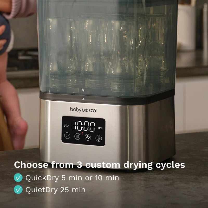 Baby brezza sterilizer bottle dryer with digital display on a kitchen counter in stainless steel
